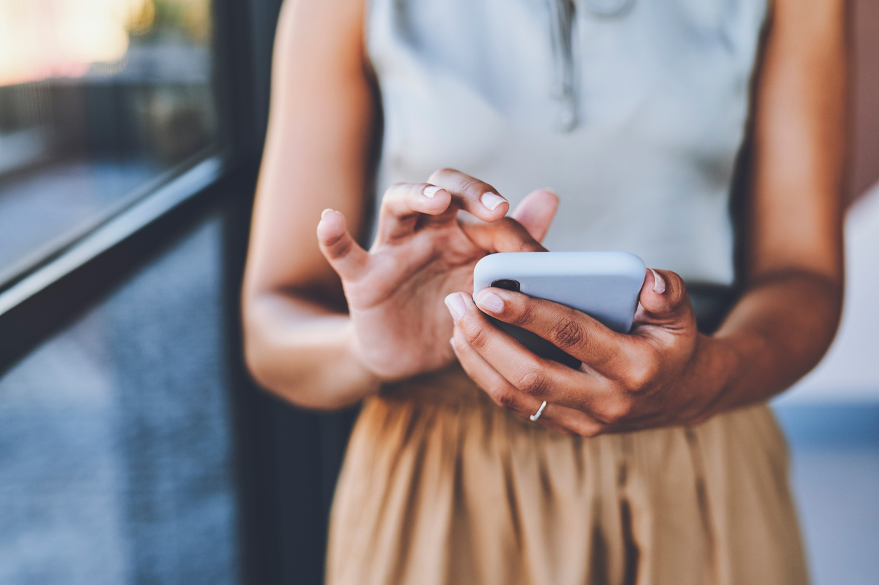 Contact us - woman holding a mobile phone.