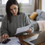 Women checking her budget at home.